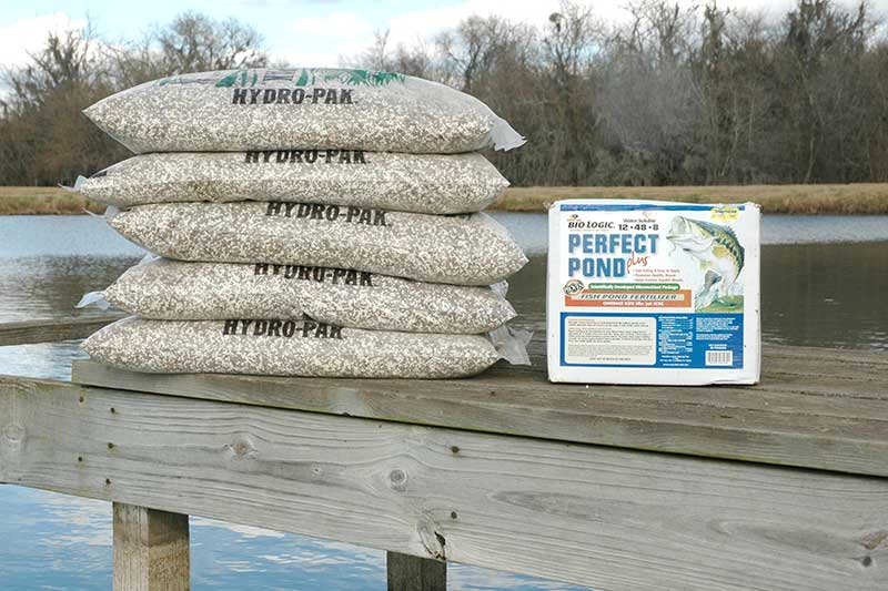 Pond Fertilization products. Five bags of hydro-pak stacked on dock.