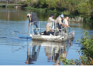 men on a lake survey boat